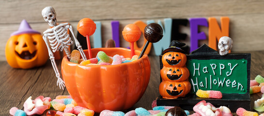 Happy Halloween day with ghost candies, pumpkin bowl, Jack O lantern and decorative (selective focus). Trick or Threat, Hello October, fall autumn, Festive, party and holiday concept