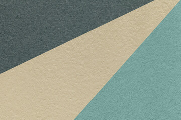 Texture of old craft beige, blue and black color paper background, macro. Vintage abstract cerulean cardboard.