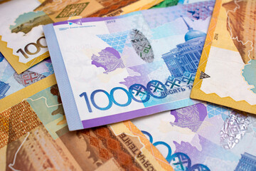 Banknote 10000 tenge. Photo of Kazakhstan cash. Banknotes of paper money - Kazakh tenge. Salary, currency exchange, travel, trip, debt, loan, rich, bribe, tax. Stack of multicolored money