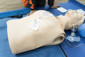 Demonstrating CPR (Cardiopulmonary resuscitation) training medical procedure on CPR doll in the class.Doctor and nurse students are learning how to rescue the patient.First aid for safe life concept.