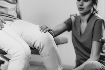 Physical Therapist Working with Leg. Senior Woman