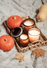 Obraz na płótnie Canvas Wicker tray with candles and pumpkins.