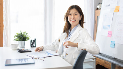 Office worker with a beautiful Asian woman in a private office, Daily routine of office workers, Welcome to work in the morning with a bright smile, Businesswoman in office concept.