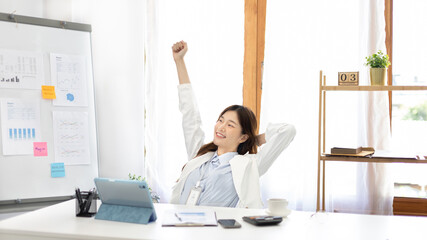 Female employee is doing a relaxing posture after a hard Midday's work, Happy women resting at work after work is finished, Fatigue is eased, Relax, Attractive, Stretch oneself, Stretch out the arms.