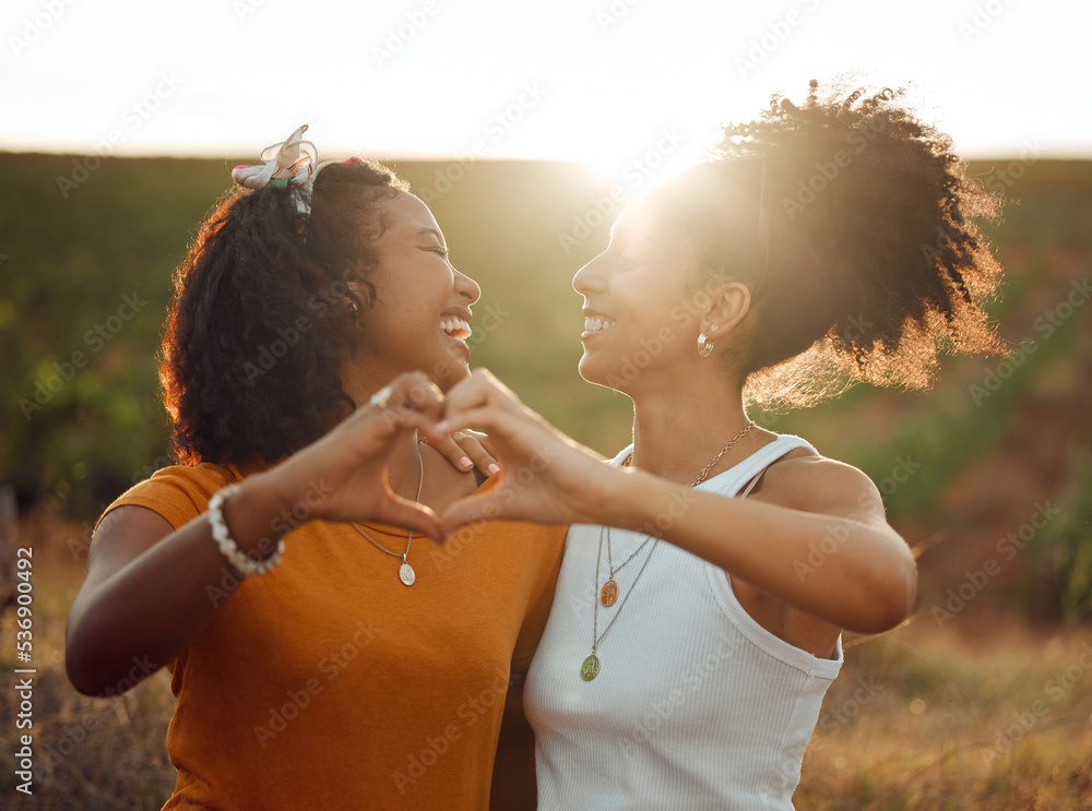 Wall mural Love, heart and hand sign by lesbian, couple travel and bond in nature at sunset, happy and relax. Freedom, romance and black women embracing in celebration of their relationship with emoji hands