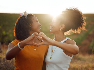 Love, heart and hand sign by lesbian, couple travel and bond in nature at sunset, happy and relax....