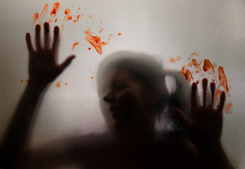 Shadowy figure, child with blooded hands behind glass - horror background