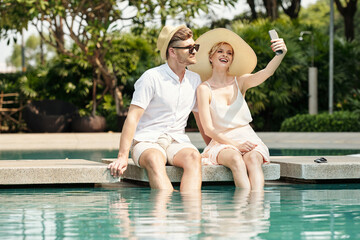 Fototapeta na wymiar Couple taking selfie at resort