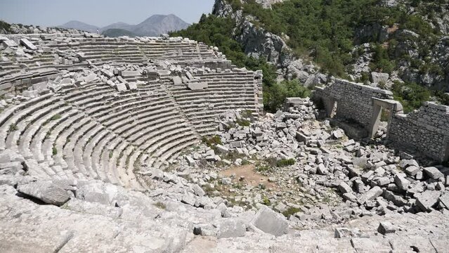 Picturesque landscape overlooking the ruins of the Roman amphitheater in the ancient city of Termessos, currently located near Antalya, Turkey. High quality 4k footage