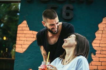 Beautiful loving couple sitting in a cafe drinking coffee and enjoying in conversation.