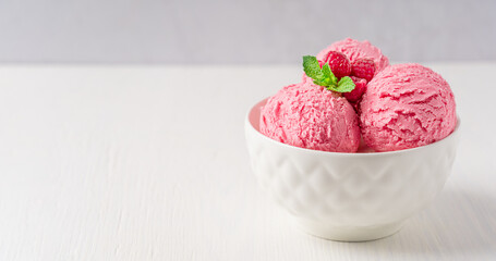Three scoops of sweet frozen homemade berry ice cream or organic sorbet decorated with juicy...