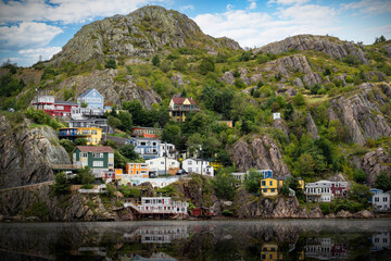 The Battery Road jelly bean homes on the rocky shores of St John's Harbour in Newfoundland Canada.