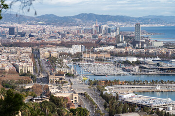 View of Barcelona Cityscape and sea shore with mountains on background. Vacation and travel concept
