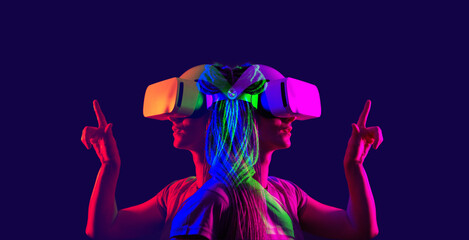 Woman is using virtual reality headset. Image with double color exposure effect.