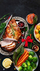 Traditional Christmas dinner on dark background.