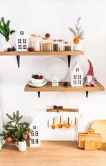 front view of the wooden countertop and shelves in the interior of the modern kitchen with utensils and Christmas decorations. ecologically kitchen.