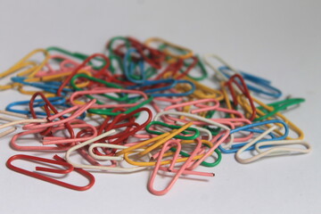 pile of colorful used paper clips on a white background
