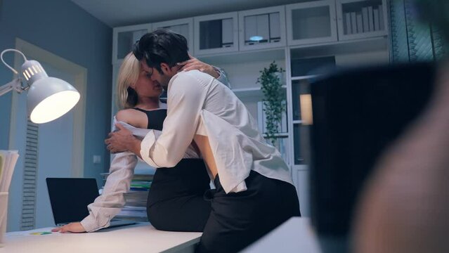 Caucasian businessman and woman foreplay and making love in the office