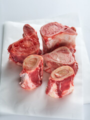 Beef Bones for Making Broth on white paper. Raw beef bones for soup.