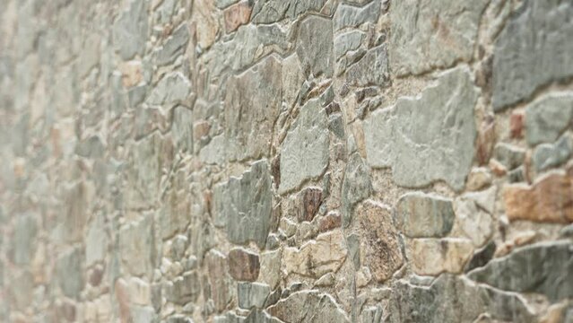 Old dirty decorative natural stone wall with rock texture closeup