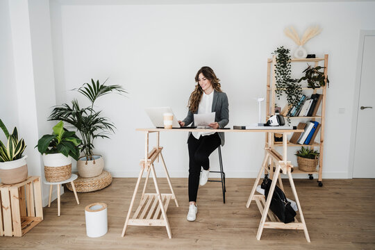 Young Female Engineer Working In Modern Office Sitting At Desk