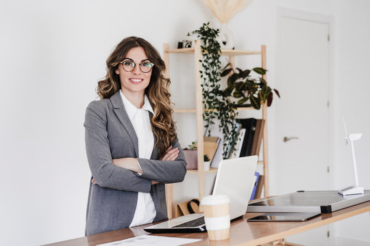 Confident Female Engineer Standing In Her Modern Office With Arms Crossed