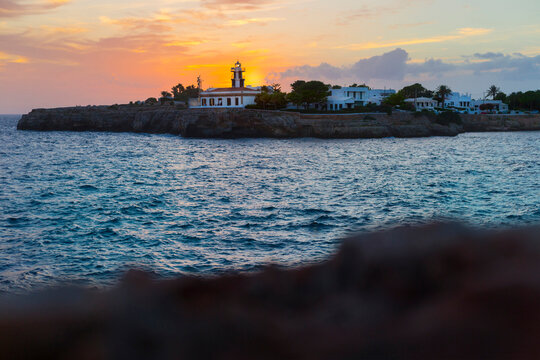 Spain, Balearic Islands, Ciutadella de Menorca,&nbsp;Punta de Sa Farola lighthouse at sunset