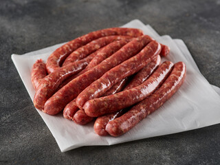 Raw Beef bratwurst. German sausages. Rinderbratwurst. Fresh raw beef sausages. Close up.