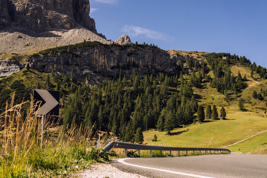 Scenic view of mountains next to road on sunny day