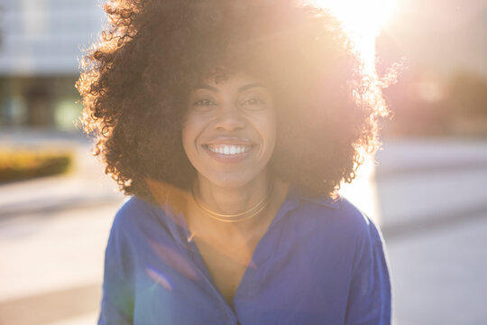 Happy Woman With Afro Hairstyle On Sunny Day