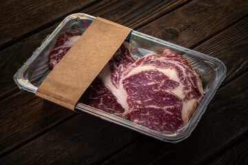 Beef steak in vacuum packaging. Template for meat packaging with an empty space for the logo on...