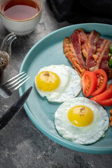 Two Fried egg with bright yolk on a plate with English breakfast