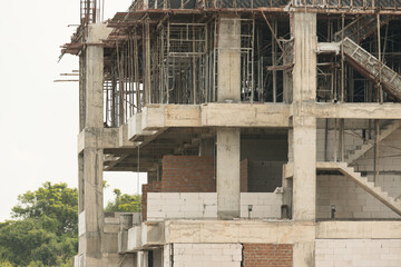Fototapeta na wymiar Unfinished cement building at a construction site.Cement pouring into formwork of building at construction site.A new residential build concept.