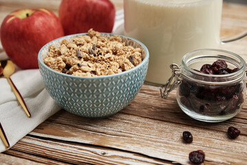 Granola with milk in blue bowl on wooden table, Healthy organic breakfast with muesli, Food clean eating concept