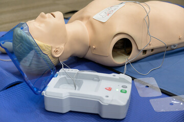 Demonstrating CPR (Cardiopulmonary resuscitation) training medical procedure on CPR doll by...