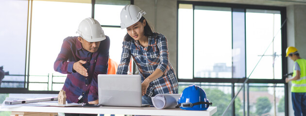 two architect look at blueprint and planning to renovation room.