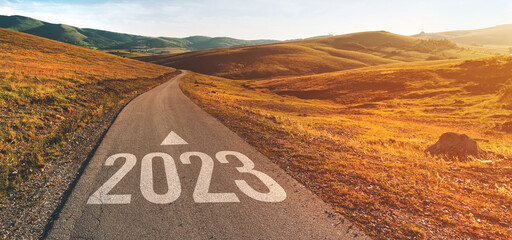 2023 ahead, new year number on winding road through beautiful countryside landscape