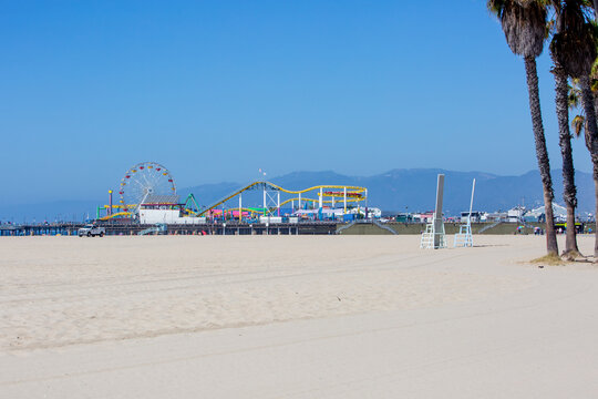 Photo For Pacific Park With Ferris Wheel On The Santa Monica Pier Over Beach Sand On Bright Sunny Daytime