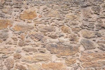 Old wall with stones and mud