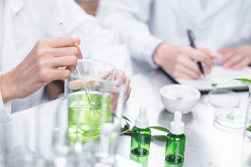 Fototapeta premium chemistry scientist working on biotechnology cosmetic research with natural herb medicine ingredient in biology science laboratory, organic bio eco beauty extract in botany experiment for dermatology