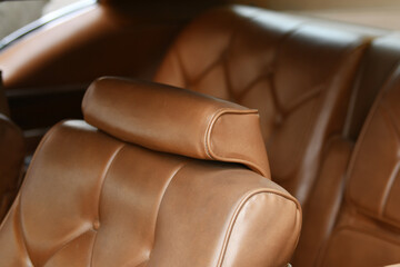 A brown vintage armchair in a car interior