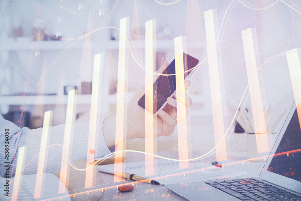 Poster double exposure of man's hands holding and using a digital device and forex graph drawing. financial