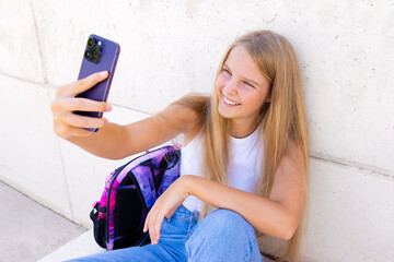 Teenage girl making video call on mobile phone