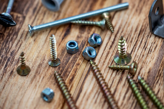 image of sets of plastic dowels shiny metal self-tapping screws in  pile on  table background.