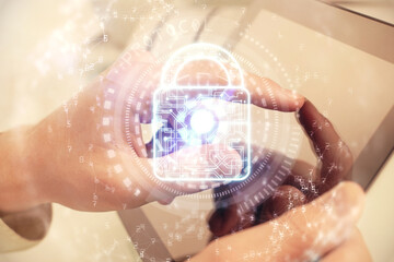 Multi exposure of man's hands holding and using a digital device and lock drawing. Security concept.