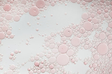 Abstract pink oil bubbles background. Cosmetic liquid beauty product.