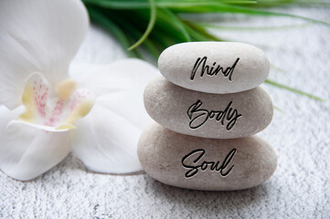 Mind, Body and Soul words engraved on zen stones with space for text. Health life concept