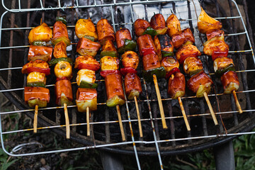 barbeque time with sausage satay and paprika vegetables grilled on a hot plate