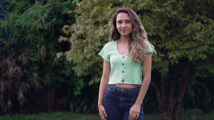 One young Brazilian 20s girl standing outside looking at camera