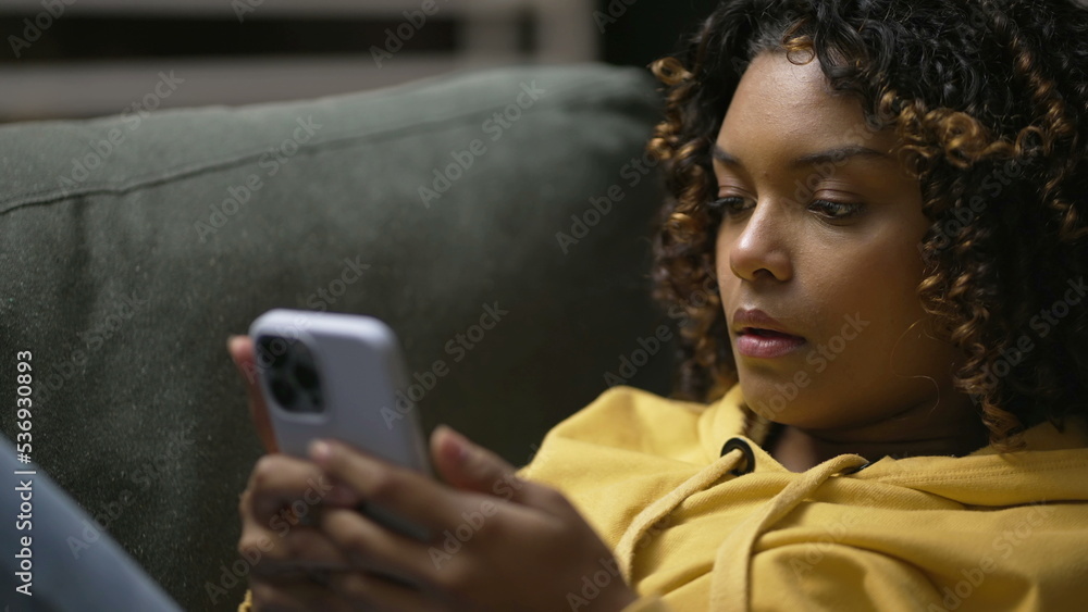 Wall mural one frustrated young black woman angry on social media cellphone device. upset african american girl